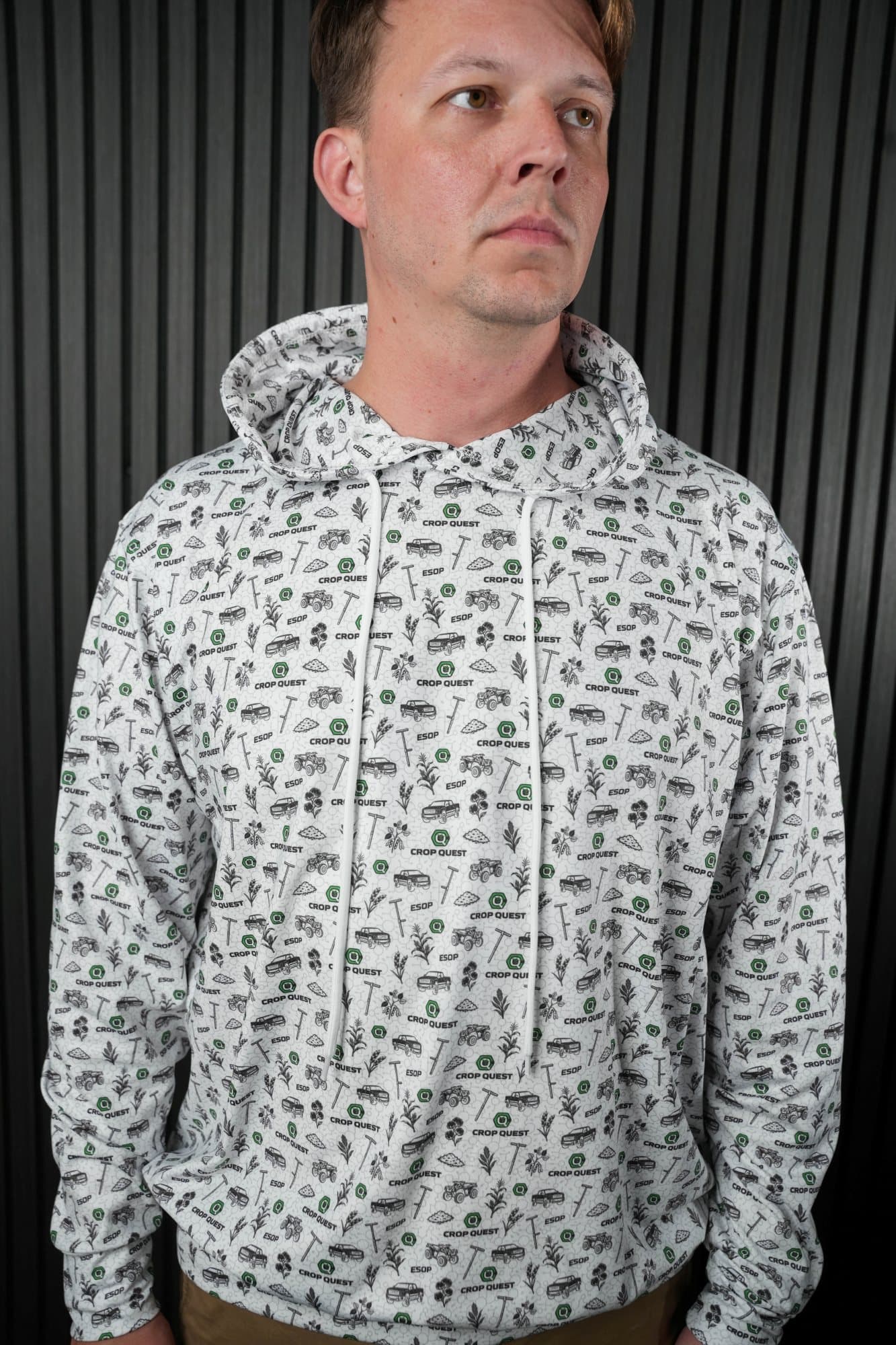 Man in a white and grey all-over print hoodie in a studio