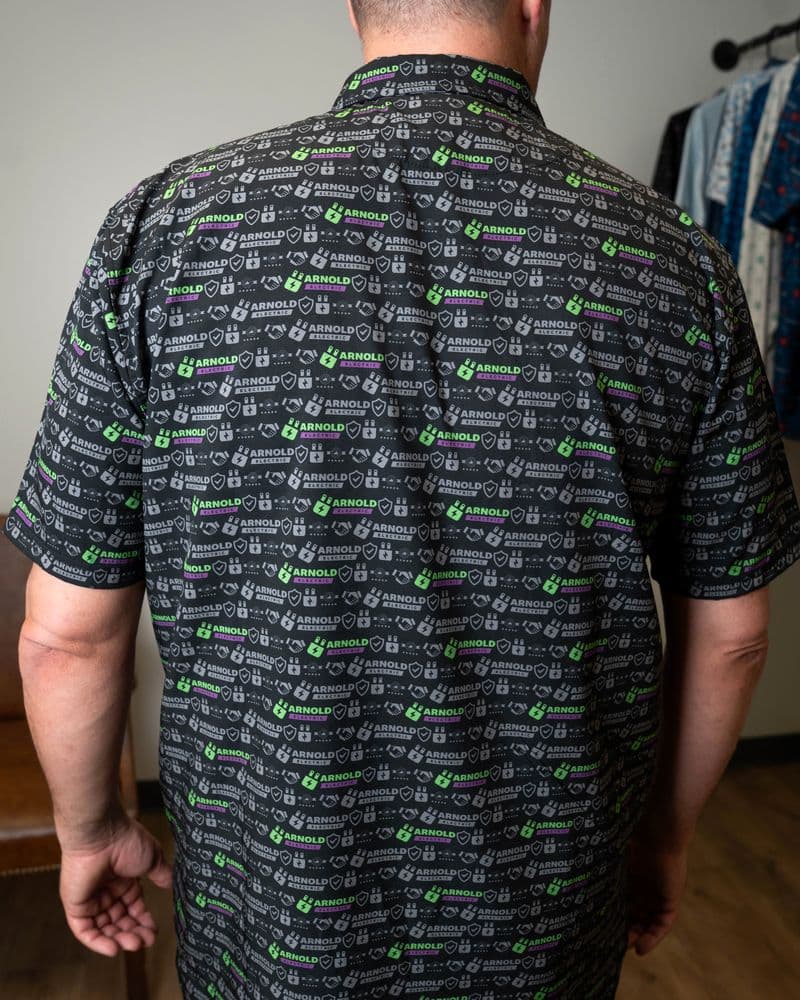 Back of the black button-up, print across the back and short sleeves.