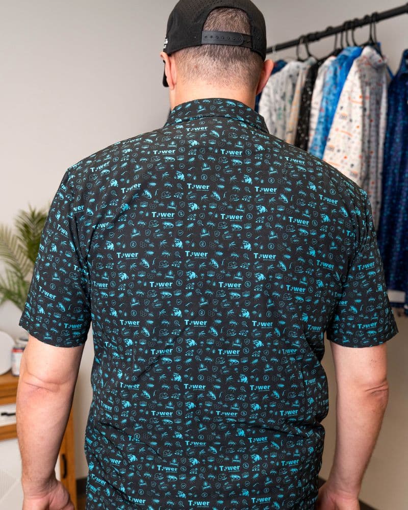 Back of the teal-on-black button-up, print across the back and short sleeves.