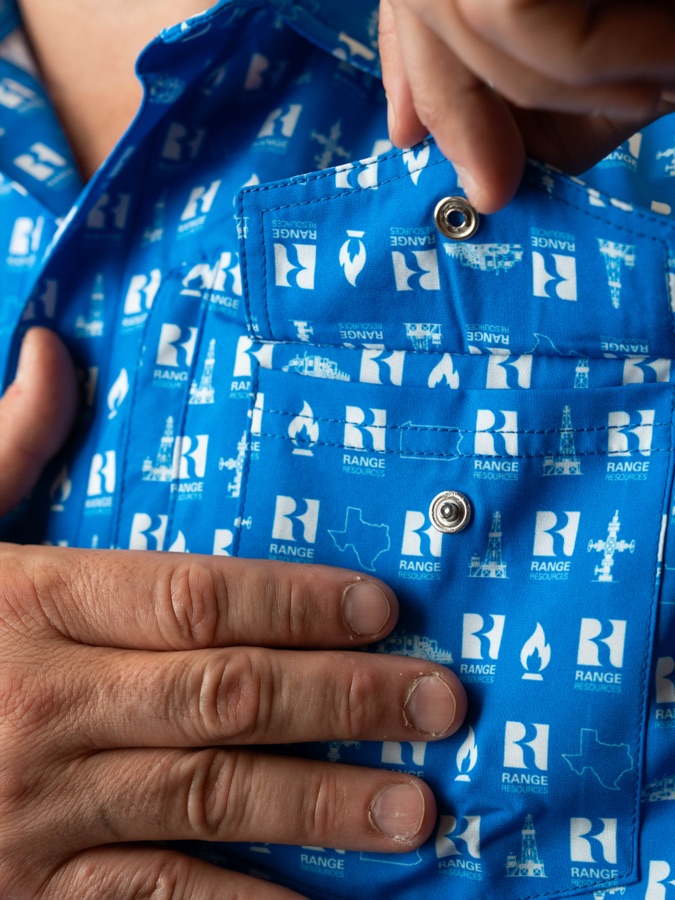 Blue custom snap button-up, snap being fastened